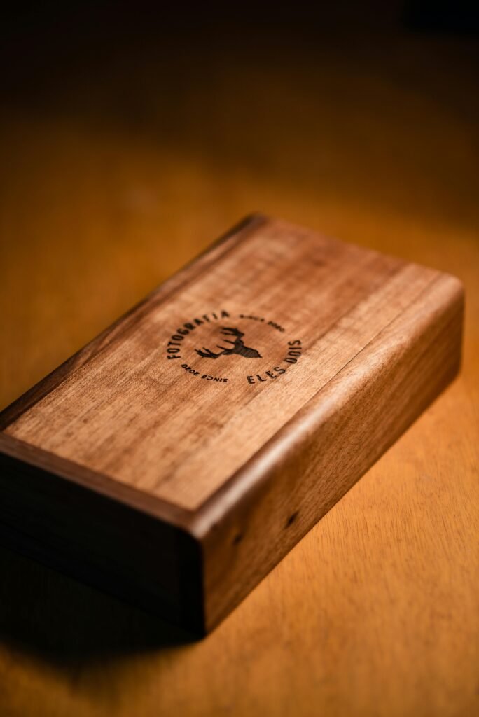 pexels-photo-13625513-13625513 A beautifully crafted wooden box featuring an engraved deer design, set on a warm-toned surface.